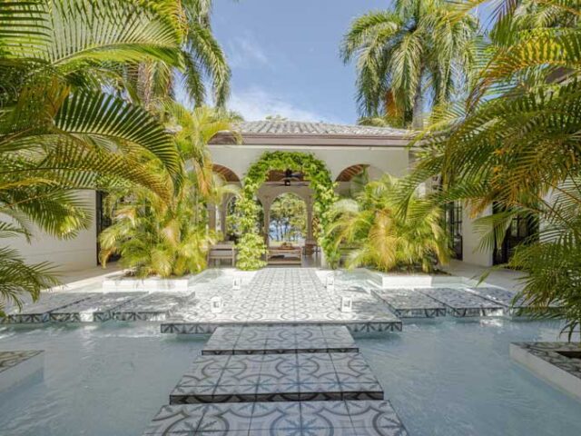 Luxurious 6-bedroom villa in Sea Horse Ranch, Cabarete, Dominican Republic, featuring modern eclectic design, private guest house, Bali-tiled pool, and lush tropical gardens